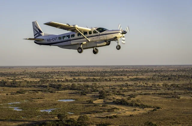 Nature Romp safari vehicle crossing a golden East African landscape